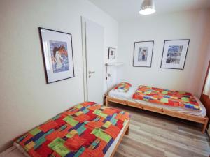 a bedroom with two beds and a quilt at Apartment Les Bouillets by Interhome in Veysonnaz