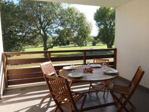 a table and chairs on a balcony with a view at Apartment Le Golf Clair-1 by Interhome in Saint-Cyprien
