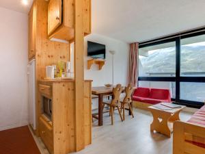 a kitchen and living room with a table and a couch at Apartment Brelin La Challe 635 by Interhome in Les Menuires +23 photos