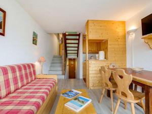 a living room with a couch and a table at Apartment Brelin-8 by Interhome in Les Menuires