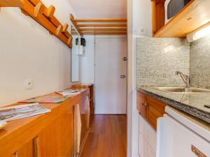 a kitchen with wooden counters and a sink at Apartment Chavière-5 by Interhome in Les Menuires