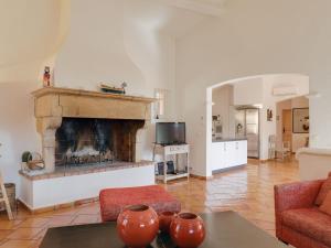 a living room with a fireplace and a table at Villa Le Petit Rouveau by Interhome in Guerre Vieille