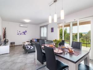 a dining room and living room with a table and chairs at Holiday Home Marina by Interhome in Labin