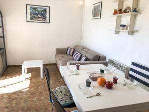 a living room with a table and a couch at Apartment Les Agathes Plus by Interhome in Cap d'Agde