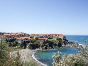 a group of houses on a hill next to the ocean at Apartment Les Roches Bleues-5 by Interhome in Collioure