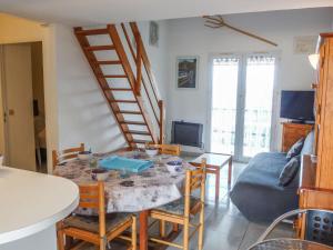 a living room with a table and chairs and a staircase at Apartment Les Roches Bleues-5 by Interhome in Collioure