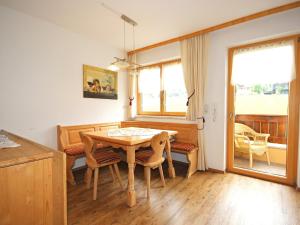 a dining room with a table and chairs and a window at Apartment Christian by Interhome in Fügen