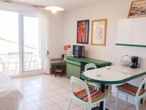 a living room with a table and a desk at Apartment Thalacap by Interhome in Banyuls-sur-Mer