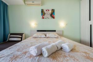 A bed or beds in a room at Happy Holiday Sozopol