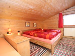 a bedroom with a bed in a wooden cabin at Apartment Annelies-3 by Interhome in Mühlfeld