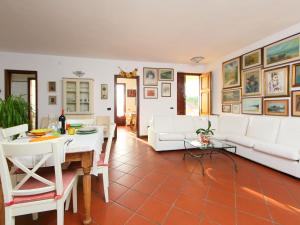 a living room with white furniture and a table at Holiday Home Olivo by Interhome in Massarosa