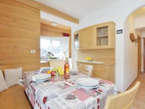 a kitchen with a table with a table cloth on it at Apartment Cincelli - Latemar by Interhome in Pozza di Fassa