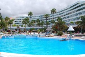 a large swimming pool in front of a large hotel at Studio in beachfront complex in El Duque area, Costa Adeje in Adeje