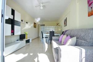 a living room with a couch and a table at Studio in beachfront complex in El Duque area, Costa Adeje in Adeje