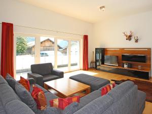 a living room with a couch and a table and a tv at Apartment Living House Vandans by Interhome in Vandans