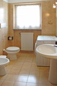 ein Badezimmer mit einem WC, einer Badewanne und einem Waschbecken in der Unterkunft Apartment Martinelli by Interhome in Calceranica al Lago