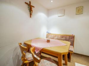 a dining room with a table with a pink napkin on it at Apartment Christian by Interhome in Pettneu am Arlberg