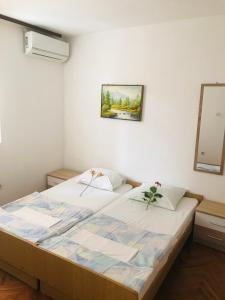 a bedroom with a large bed in a room at Apartments MM Budva in Budva