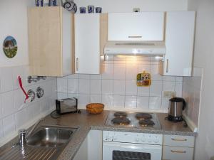 a kitchen with a sink and a stove top oven at Apartment Schwarzwaldblick-13 by Interhome in Obertal