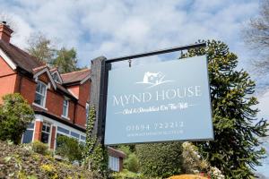 a sign for a wind house in front of a house at Mynd House in Church Stretton