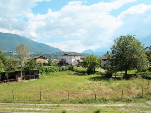 a field with houses and trees and a fence at Holiday Home Casa al Mulino by Interhome in Calceranica al Lago