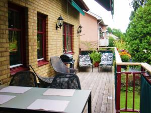 a patio with tables and chairs and a building at At Home Bed & Breakfast in Gothenburg