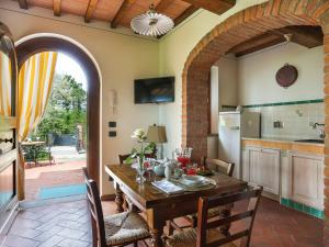 a dining room with a table and a kitchen at Holiday Home Villa I Cipressi by Interhome in Nievole