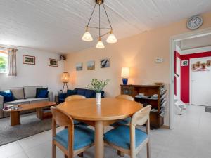 a dining room and living room with a table and chairs at Holiday Home Sint Kruis by Interhome in Sint Kruis