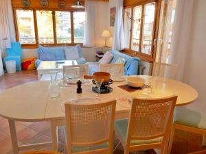 a dining room with a table and chairs and a couch at Apartment Ambassador I Apt 7 by Interhome in Nendaz