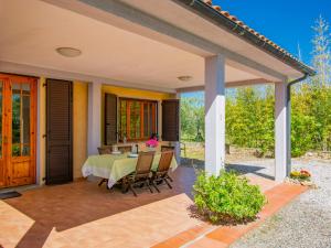 a patio with a table and chairs on a patio at Apartment Montaleo 1 by Interhome in Casale Marittimo