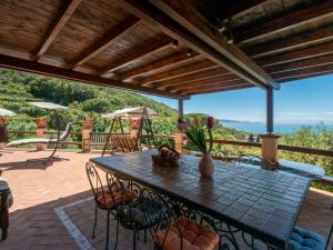 a patio with a table and chairs with a view at Villa Ricali by Interhome in Porto Santo Stefano