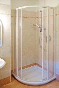 a shower with a glass door in a bathroom at Apartment Giovanni - CPO359 by Interhome in Campitello