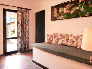 een woonkamer met een bank en een raam bij Apartment Bardeggiano - Caterina 3 - COL246 by Interhome in Belvedere