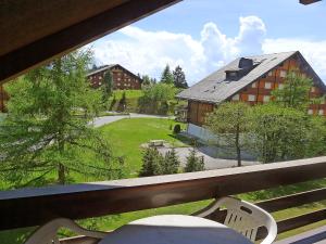 a view of a house from a balcony at Apartment Grenat 35 by Interhome in Villars-sur-Ollon