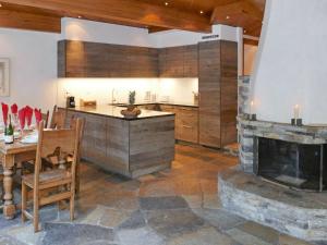 a kitchen with a stone fireplace and a table and a counter at Holiday Home Les Clèves by Interhome in Nendaz +39 photos