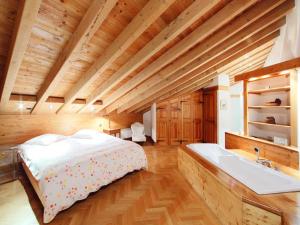 a bedroom with a bed and a bath tub at Holiday Home Les Clèves by Interhome in Nendaz