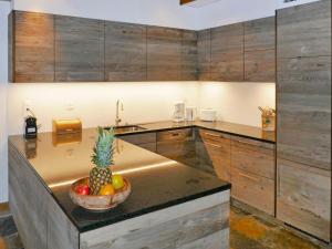 a kitchen with a bowl of fruit on a counter at Holiday Home Les Clèves by Interhome in Nendaz +39 photos