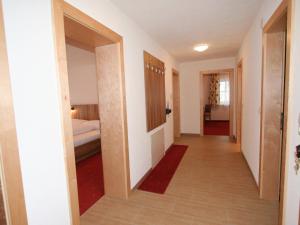 a corridor of a room with a bedroom and a bed at Apartment Pfeifer-1 by Interhome in Pians +13 photos