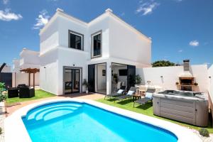 a white villa with a swimming pool at Villa Ariome in Playa Blanca
