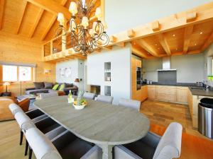 a dining room and living room with a table and chairs at Chalet Chalet Jadi by Interhome in Nendaz