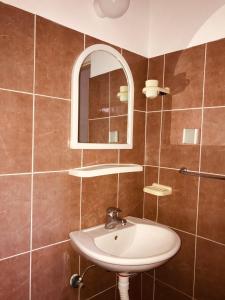 a bathroom with a sink and a mirror at Apartments MM Budva in Budva