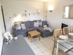 a living room with a couch and a table at Apartment Barzettes-Vacances 454 - Entrée N- 14 by Interhome in Vermala