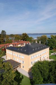 an overhead view of a building with a black roof at Evangelische Akademie Tutzing in Tutzing