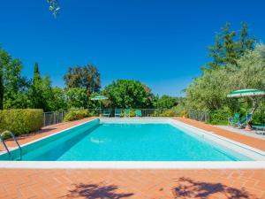 a swimming pool with blue water in a yard at Apartment Montaleo 5 by Interhome in Casale Marittimo