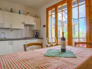 a bottle of wine and two glasses on a table at Apartment Montaleo 5 by Interhome in Casale Marittimo