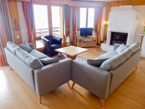 a living room with two couches and a fireplace at Apartment Le Bristol C54 by Interhome in Villars-sur-Ollon