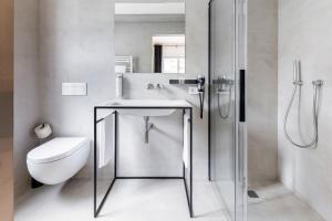 a bathroom with a sink and a toilet at Casa al Sole in Ortisei