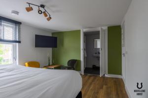 Säng eller sängar i ett rum på Hostellerie Horst