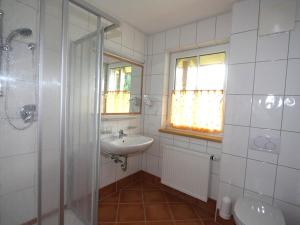 a white bathroom with a sink and a shower at Apartment Hofresidenz-3 by Interhome in Altenmarkt im Pongau