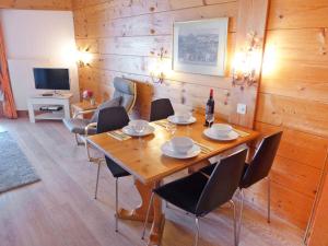 a dining room with a wooden table and chairs at Apartment Le Bristol A54 by Interhome in Villars-sur-Ollon